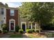 Charming townhome with black front door, bay window, and manicured landscape at 2273 Aston Mill Pl, Charlotte, NC 28273