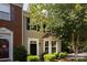 Charming townhome with black front door, bay window, and beautiful landscape at 2273 Aston Mill Pl, Charlotte, NC 28273