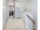 Bright hallway featuring neutral carpet, white walls, built-in shelving, and decorative pendant lighting at 2273 Aston Mill Pl, Charlotte, NC 28273