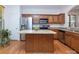 Spacious kitchen featuring stainless steel appliances, a center island, and wood cabinetry at 2273 Aston Mill Pl, Charlotte, NC 28273