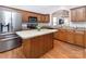 Modern kitchen featuring stainless steel appliances, wood cabinets, and island with open layout at 2273 Aston Mill Pl, Charlotte, NC 28273
