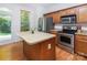 Well-equipped kitchen featuring stainless steel appliances and wood cabinets and an island at 2273 Aston Mill Pl, Charlotte, NC 28273