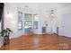 Inviting living room featuring hardwood floors, large windows, and a bay window seat at 2273 Aston Mill Pl, Charlotte, NC 28273