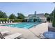 Community pool with plenty of seating, a pool house, and lush landscaping at 2273 Aston Mill Pl, Charlotte, NC 28273