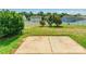 Patio in a large backyard, framed by green trees and a white fence, providing a perfect outdoor space at 2357 Riding Trail Rd, Gastonia, NC 28054