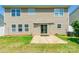 Exterior home view with a sliding door opening to a patio and a spacious, green backyard at 2357 Riding Trail Rd, Gastonia, NC 28054