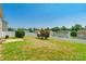 Spacious backyard features a concrete patio, framed by a white fence, and lush trees at 2357 Riding Trail Rd, Gastonia, NC 28054