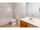 Clean bathroom features a shower and tub combo, a toilet, and a vanity with a wood cabinet at 2357 Riding Trail Rd, Gastonia, NC 28054