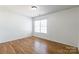 Bright bedroom with hardwood floors and a large window at 2357 Riding Trail Rd, Gastonia, NC 28054