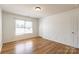 Well-lit bedroom features wood-look floors and a window, creating a comfortable and inviting atmosphere at 2357 Riding Trail Rd, Gastonia, NC 28054