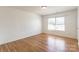 Sunlit bedroom with wood floors offers a serene atmosphere with a window providing ample natural light at 2357 Riding Trail Rd, Gastonia, NC 28054