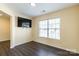 Bedroom features wood laminate flooring, a window, and a mounted television on the wall at 2357 Riding Trail Rd, Gastonia, NC 28054