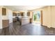 Spacious kitchen with a breakfast bar, stainless steel appliances, and sliding glass doors to the backyard at 2357 Riding Trail Rd, Gastonia, NC 28054