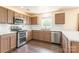 Well-equipped kitchen with stainless steel appliances, white subway tile backsplash, and wood laminate flooring at 2357 Riding Trail Rd, Gastonia, NC 28054