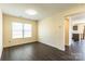 Inviting living room featuring wood laminate flooring and a view into the kitchen at 2357 Riding Trail Rd, Gastonia, NC 28054