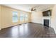 Comfortable living room featuring a fireplace, wood laminate flooring, and plenty of natural light at 2357 Riding Trail Rd, Gastonia, NC 28054