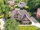 An aerial view displays a two-story brick home with a lush lawn and mature landscaping at 27246 Preston Pl, Fort Mill, SC 29707