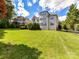 A well-manicured lawn compliments this home's rear exterior and multi-story design at 27246 Preston Pl, Fort Mill, SC 29707
