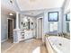 Ensuite bathroom features tiled floors, walk-in closet access, and a luxurious soaking tub at 27246 Preston Pl, Fort Mill, SC 29707