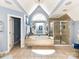 This large bathroom includes a whirlpool bathtub, glass enclosed shower and lots of natural light at 27246 Preston Pl, Fort Mill, SC 29707