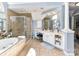 Bright primary bathroom with soaking tub, glass shower, and vanity with makeup area at 27246 Preston Pl, Fort Mill, SC 29707
