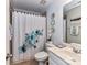 Fresh bathroom featuring floral shower curtain, modern vanity and decorative accents at 27246 Preston Pl, Fort Mill, SC 29707