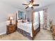 Bedroom features a four-poster bed, ceiling fan, and natural light from windows with floral-print drapes at 27246 Preston Pl, Fort Mill, SC 29707