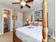 Well-lit primary bedroom features a four-poster bed and natural light from nearby windows at 27246 Preston Pl, Fort Mill, SC 29707