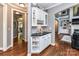 An interior hallway leads to dining area with built-in bar with cabinets, drawers, and wine storage at 27246 Preston Pl, Fort Mill, SC 29707