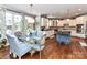 Dining and kitchen area featuring hardwood floors, modern appliances, and plenty of natural light at 27246 Preston Pl, Fort Mill, SC 29707
