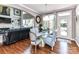 Dining area adjacent to the kitchen features a glass table and seating for four, and modern decor at 27246 Preston Pl, Fort Mill, SC 29707
