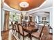 Formal dining room with elegant chandelier, hardwood floors, and large windows at 27246 Preston Pl, Fort Mill, SC 29707