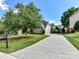 Long driveway leading to a home with a well-manicured lawn and mature trees at 27246 Preston Pl, Fort Mill, SC 29707