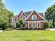 Beautiful brick home with manicured lawn and mature landscaping creates a welcoming curb appeal at 27246 Preston Pl, Fort Mill, SC 29707
