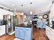 Eat-in kitchen area showcases a blue island with barstools, stainless appliances, and an adjoining dining area at 27246 Preston Pl, Fort Mill, SC 29707