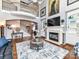 Open living room with fireplace, built-in shelves, and high ceilings overlooking a second floor at 27246 Preston Pl, Fort Mill, SC 29707