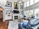 Inviting living room featuring a fireplace, built-in shelves, and high ceilings with large windows at 27246 Preston Pl, Fort Mill, SC 29707