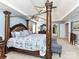 Beautifully decorated main bedroom featuring a four poster bed, sitting area, and ensuite access at 27246 Preston Pl, Fort Mill, SC 29707