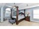 Spacious main bedroom features a canopy bed, ceiling fan, and large windows with natural light at 27246 Preston Pl, Fort Mill, SC 29707