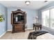 Bedroom offers an entertainment center, side table with lamp, and a large window allowing natural light at 27246 Preston Pl, Fort Mill, SC 29707