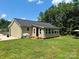 View of the back of a home featuring a sunroom and a well maintained lawn at 2921 Heavners Farm Ct, Lincolnton, NC 28092