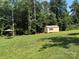 Spacious backyard featuring a storage shed and a patio set perfect for relaxing in the shade at 2921 Heavners Farm Ct, Lincolnton, NC 28092