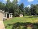 Expansive backyard featuring green grass and storage sheds, perfect for outdoor enjoyment and storage at 2921 Heavners Farm Ct, Lincolnton, NC 28092