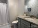 Updated bathroom features a shower with a curtain, granite vanity, and modern finishes at 2921 Heavners Farm Ct, Lincolnton, NC 28092