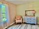Charming pink bedroom with patterned wallpaper, a vintage dresser, and a cozy armchair at 2921 Heavners Farm Ct, Lincolnton, NC 28092