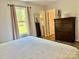 Comfortable bedroom with a dresser and lots of natural light from the large window at 2921 Heavners Farm Ct, Lincolnton, NC 28092