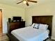 Cozy bedroom featuring a dark wood headboard, soft lighting and an inviting quilted bedspread at 2921 Heavners Farm Ct, Lincolnton, NC 28092