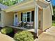 Charming front porch featuring rocking chairs and a beautifully decorated entrance, with lovely landscaping at 2921 Heavners Farm Ct, Lincolnton, NC 28092