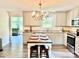 Cozy kitchen with light cabinets, granite countertops, stainless steel appliances, and a charming chandelier at 2921 Heavners Farm Ct, Lincolnton, NC 28092
