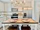 Bright kitchen featuring stainless steel appliances, granite countertops, white cabinets, and a rustic-style center island at 2921 Heavners Farm Ct, Lincolnton, NC 28092